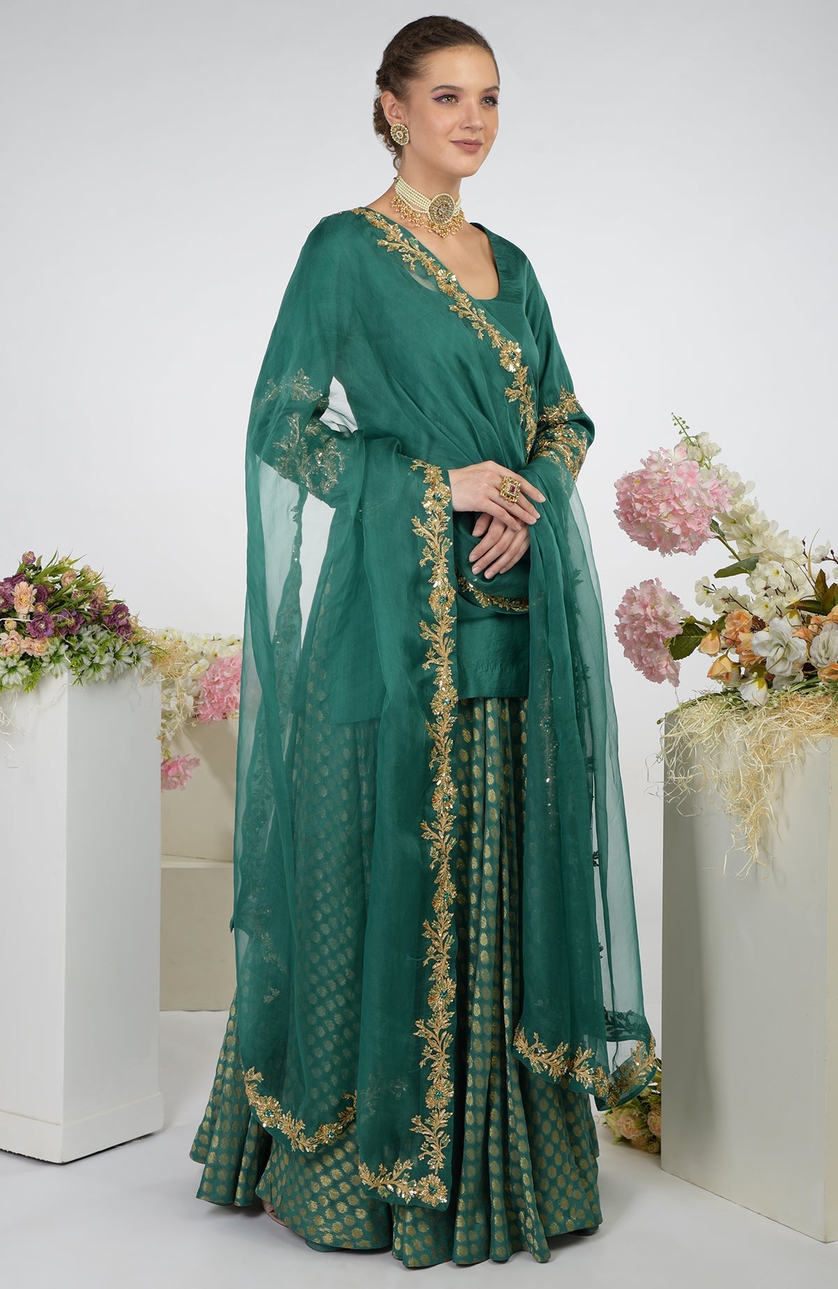 Bottle green Banarasi zardozi kalidaar skirt set with gold embroidery.