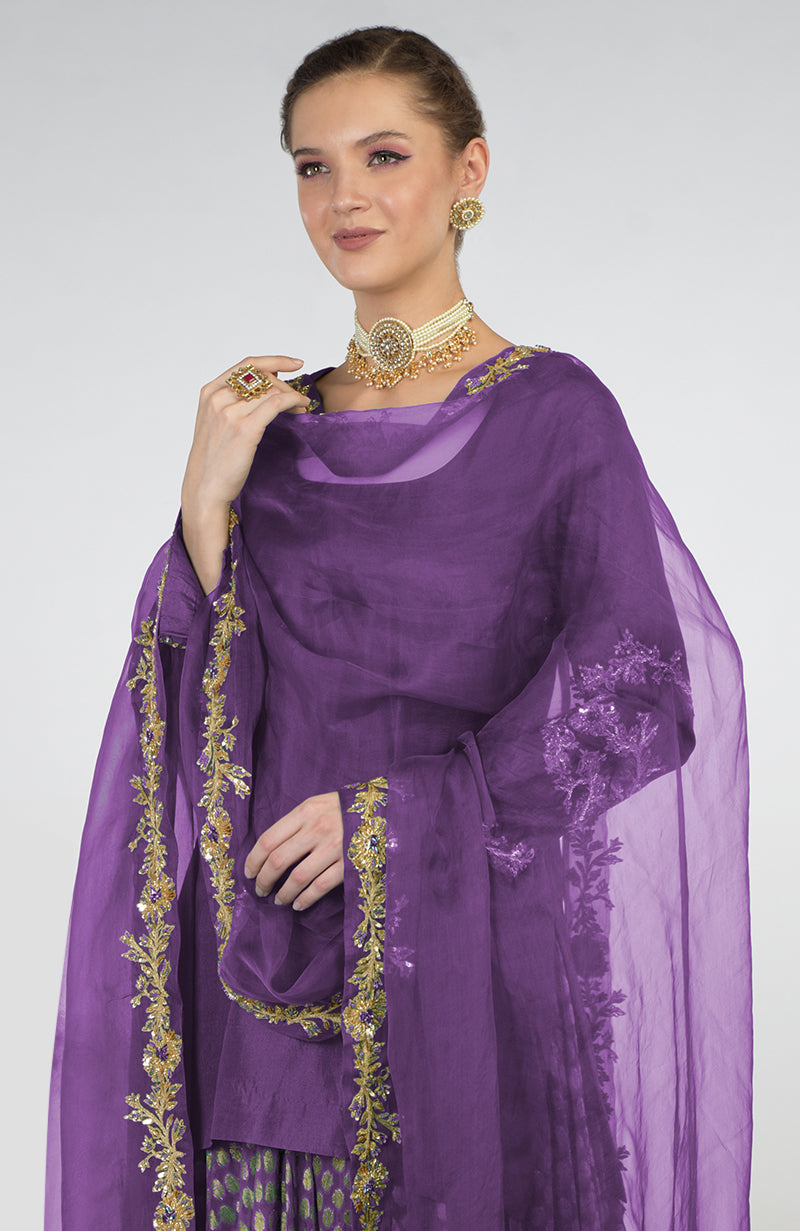 Amethyst Banarasi Zardozi Kalidaar Skirt Set with a pearl choker and earrings.
