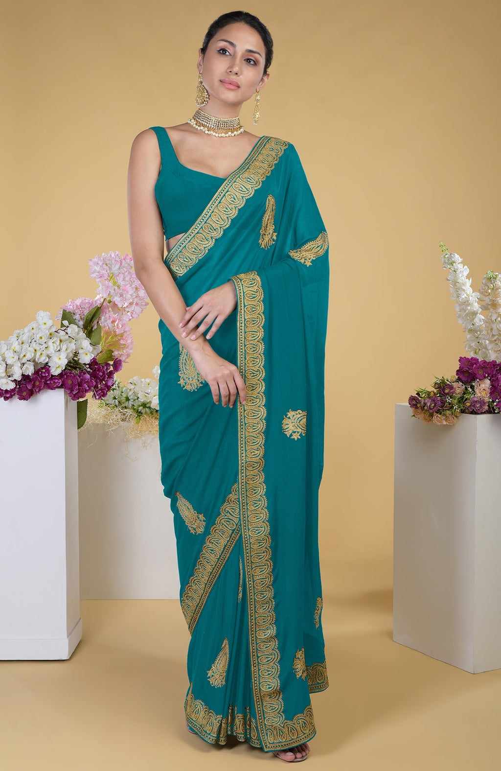 Peacock blue-gold Kashmiri tilla aari embroidered saree with a matching blouse.