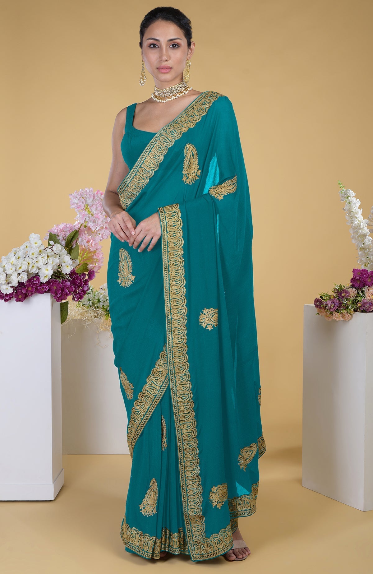 Peacock blue georgette saree with gold paisley Kashmiri tilla aari embroidery.