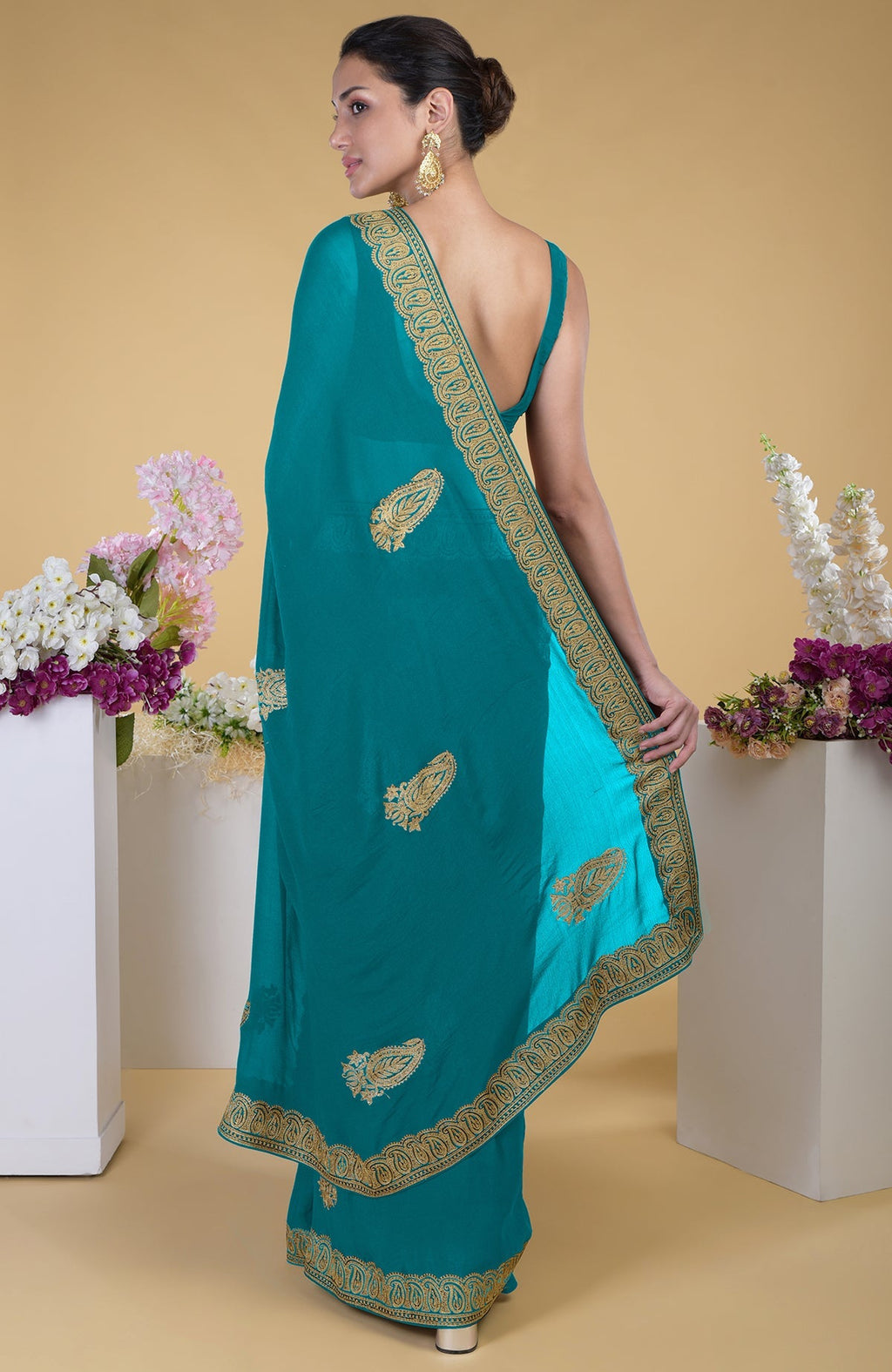 Peacock blue-gold Kashmiri Tilla Aari embroidered saree with paisley motifs.