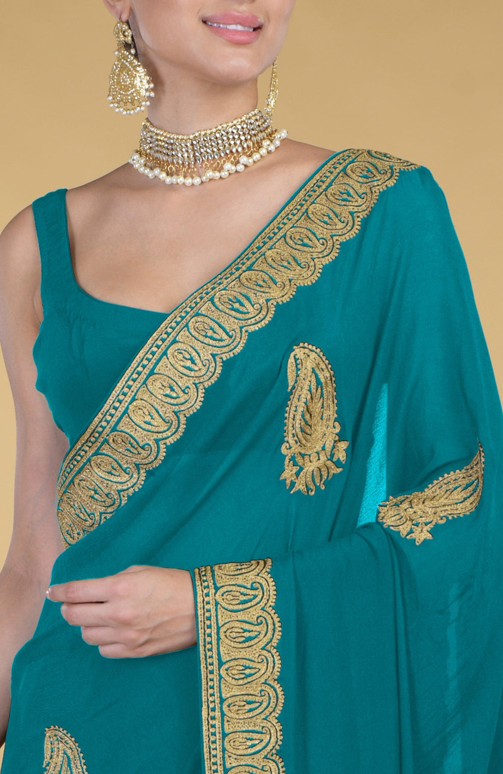 Peacock blue saree with gold Kashmiri tilla aari embroidery and matching blouse.