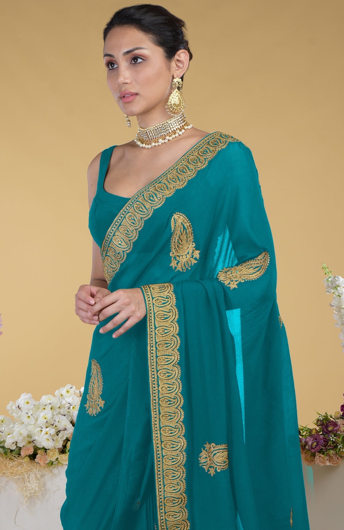Peacock blue-gold Kashmiri tilla aari embroidered saree with paisley motifs.