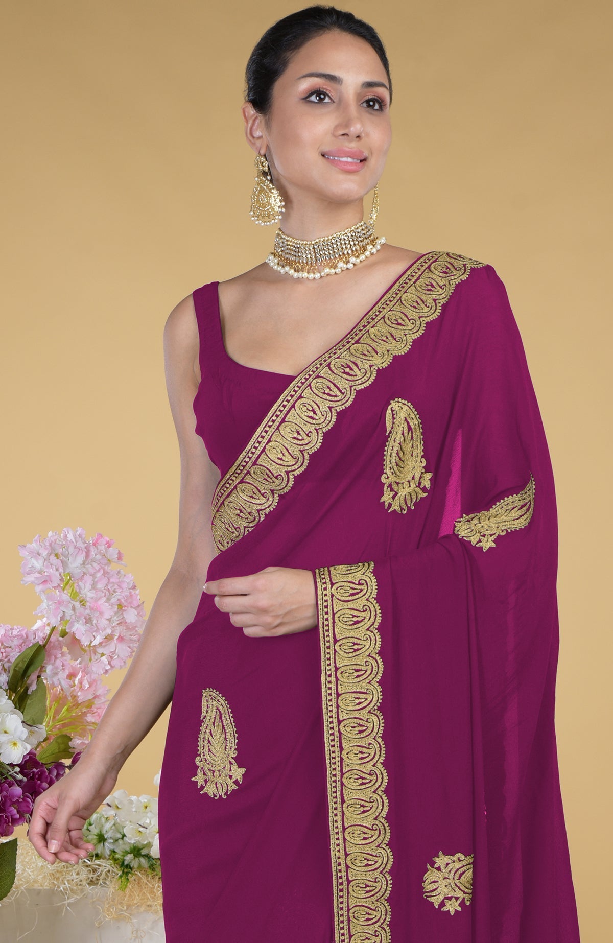 Peacock pink georgette saree with gold paisley Kashmiri tilla aari embroidery.