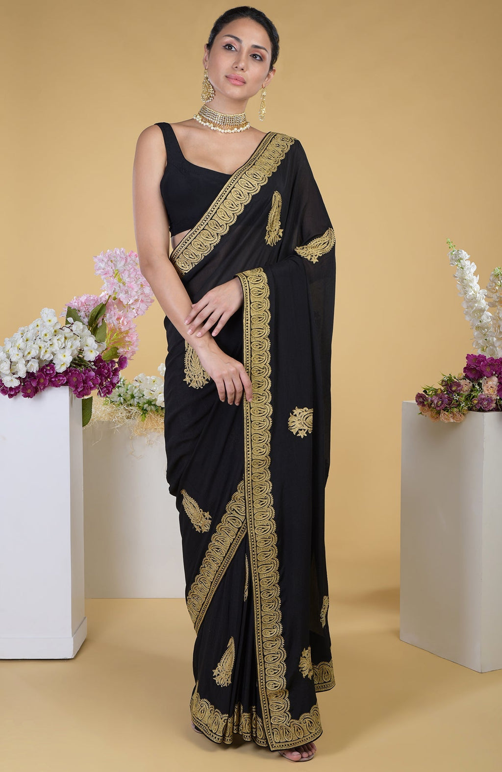 Black georgette saree with gold paisley Kashmiri tilla aari embroidery.