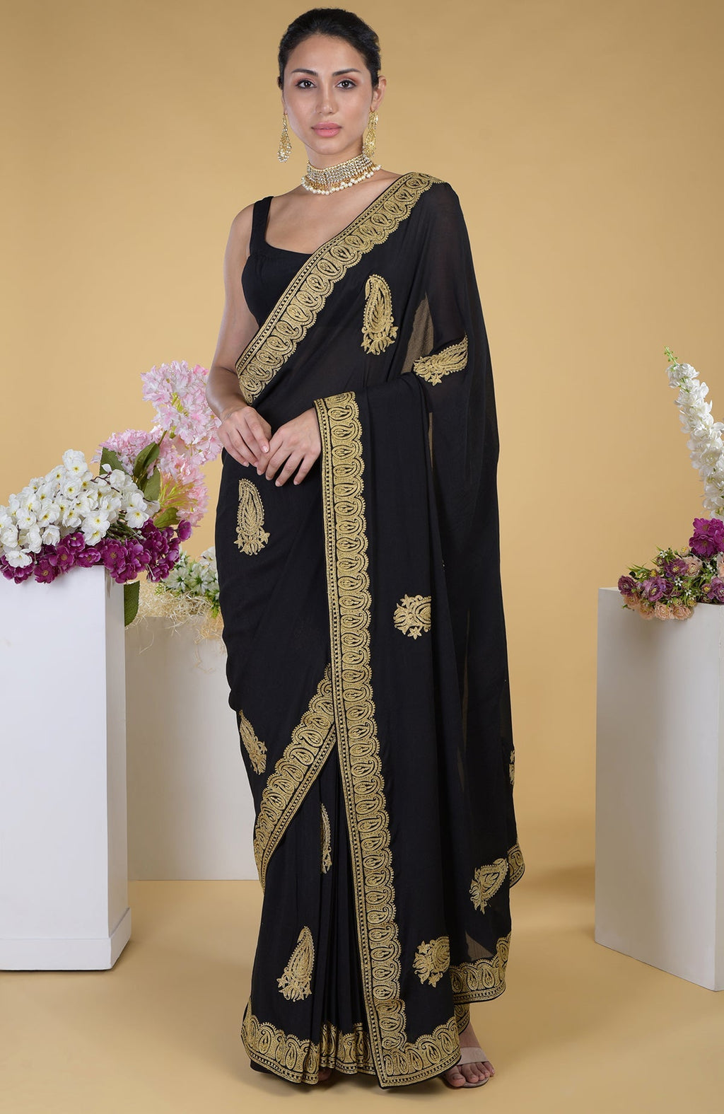 Black georgette saree with gold paisley Kashmiri tilla aari embroidery.