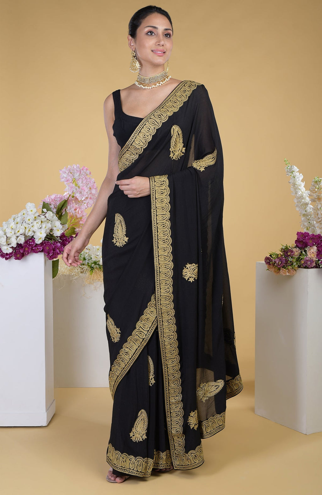 Black-gold Kashmiri tilla aari embroidered saree with paisley motifs.