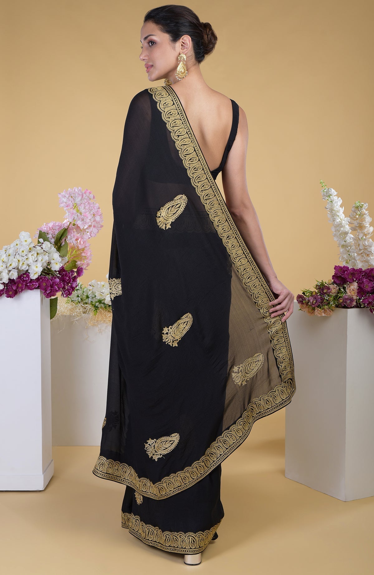 Black-gold Kashmiri tilla aari embroidered saree with paisley motifs.