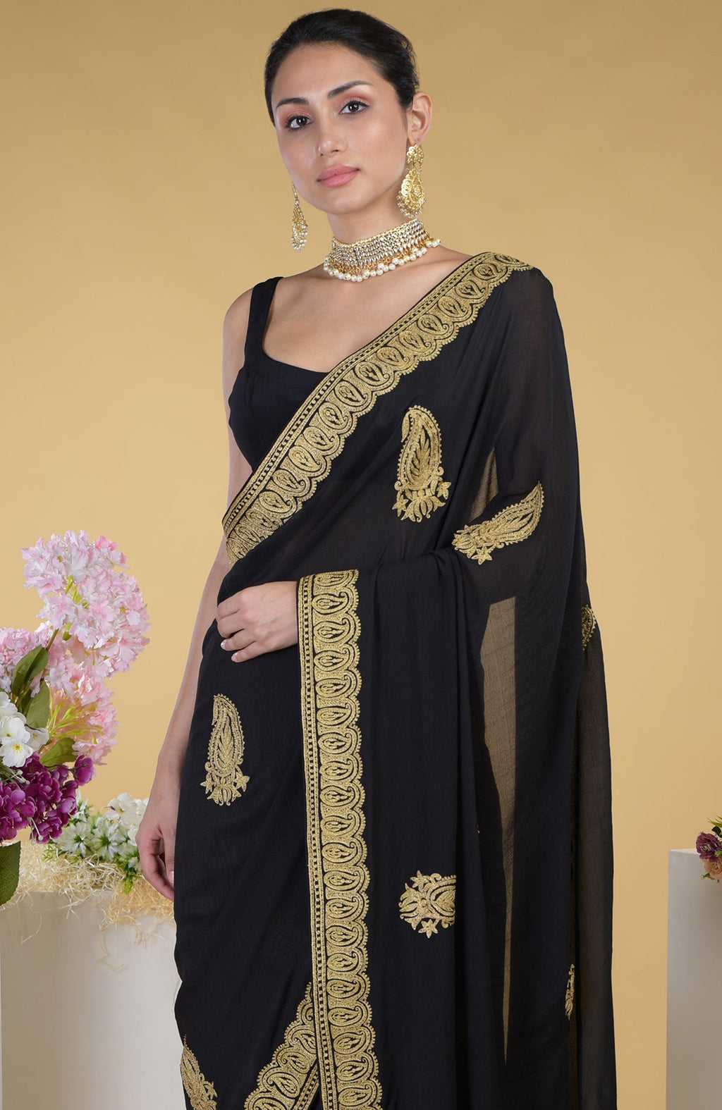 Black-gold Kashmiri tilla aari embroidered saree with matching blouse.