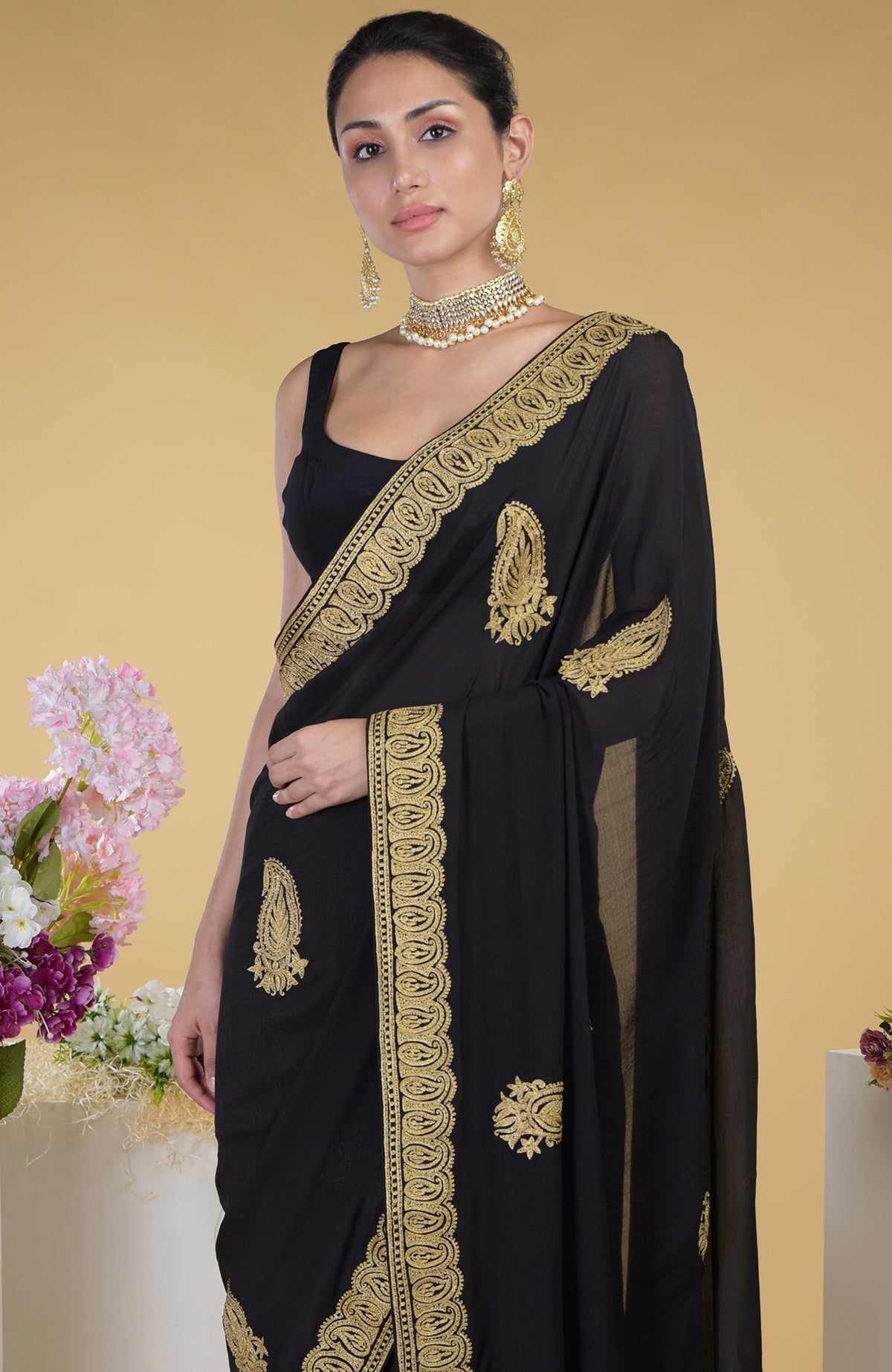 Black-gold Kashmiri tilla aari embroidered saree with matching blouse.