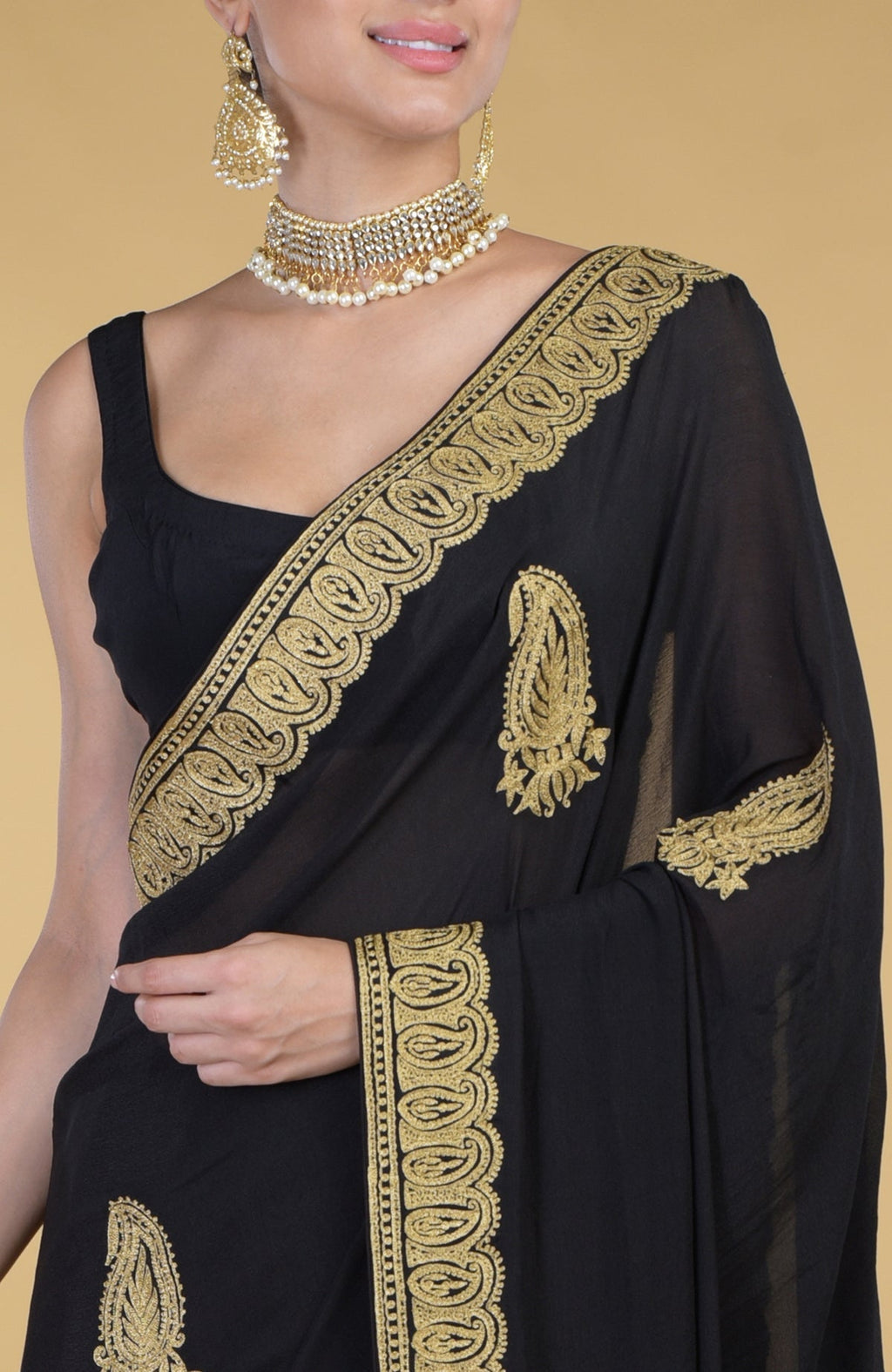 Black georgette saree with gold paisley Kashmiri tilla aari embroidery and matching blouse.