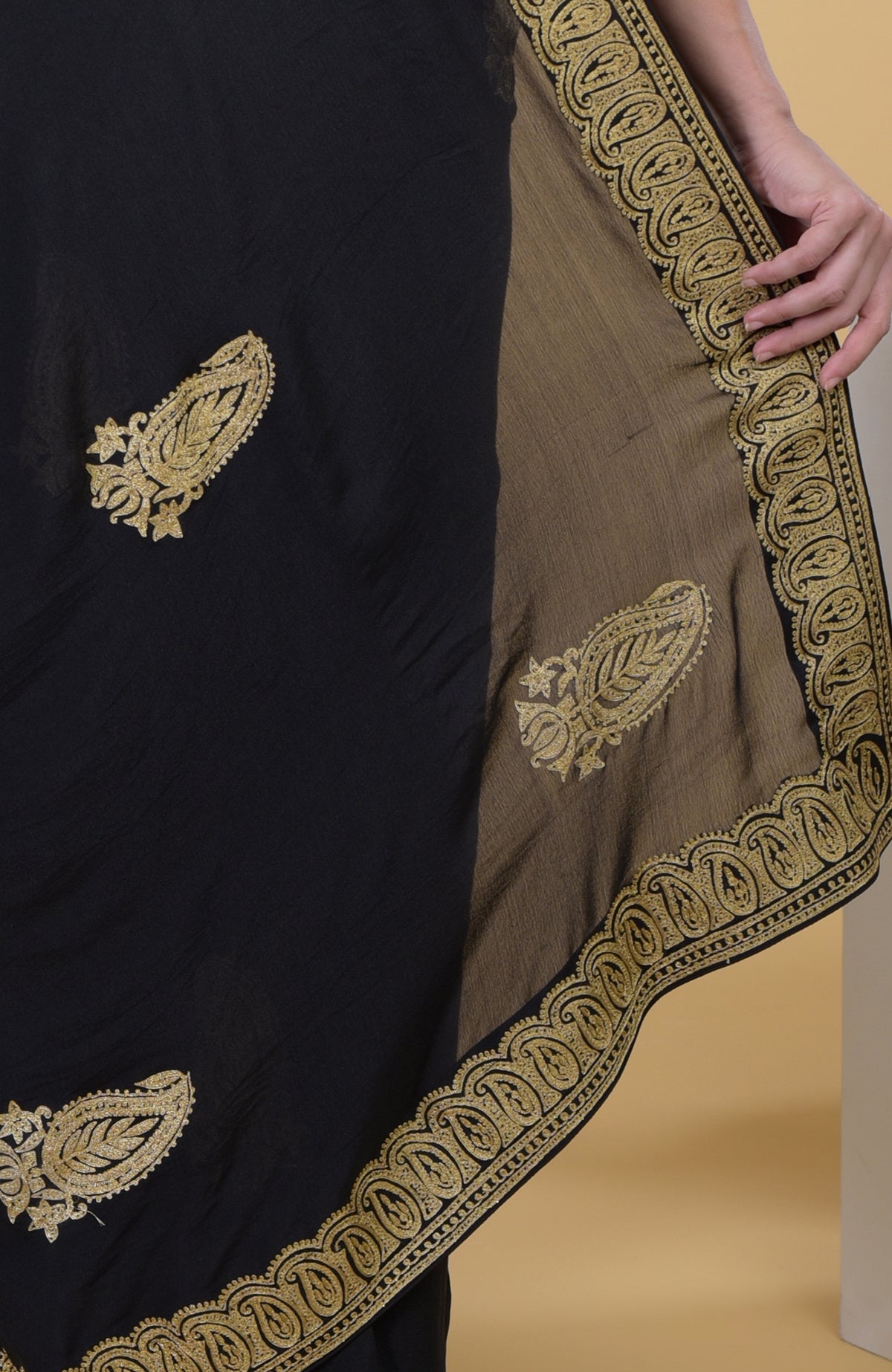 Black georgette saree with gold paisley Kashmiri tilla aari embroidery.