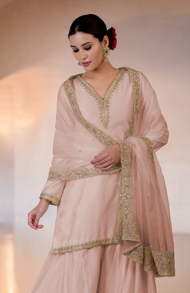 Oyster pink sharara set with gold marori and zardozi hand embroidery.
