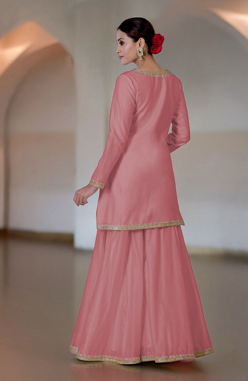 A woman models a withered rose sharara set with gold embroidery.
