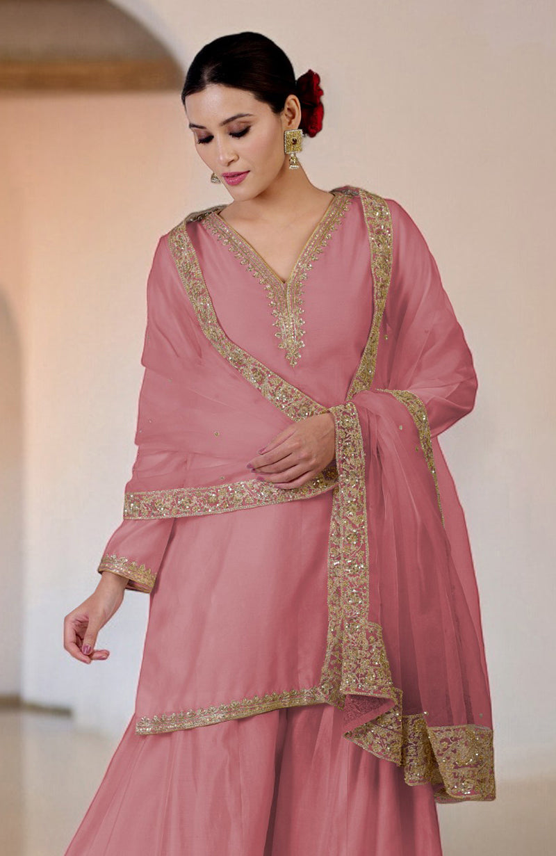 A woman models a withered rose sharara set with gold embroidery.