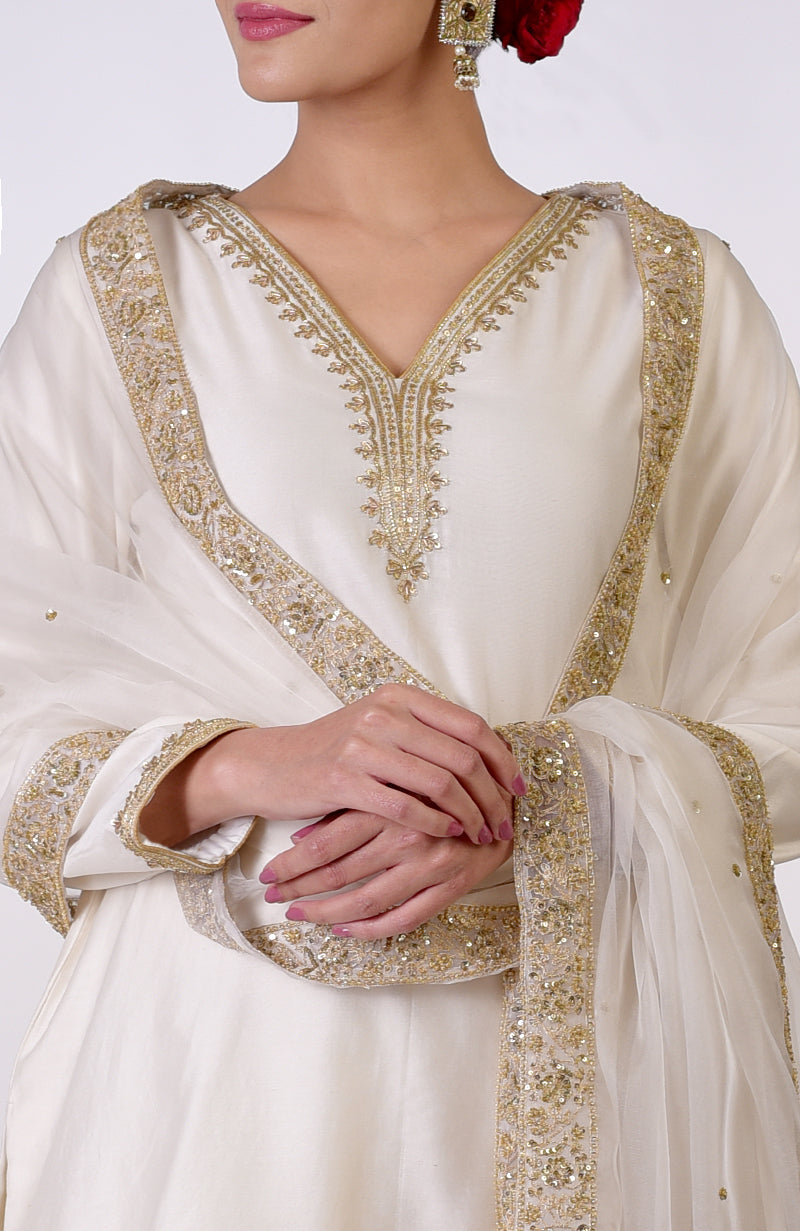 Ivory sharara set with gold marori and zardozi hand embroidery.