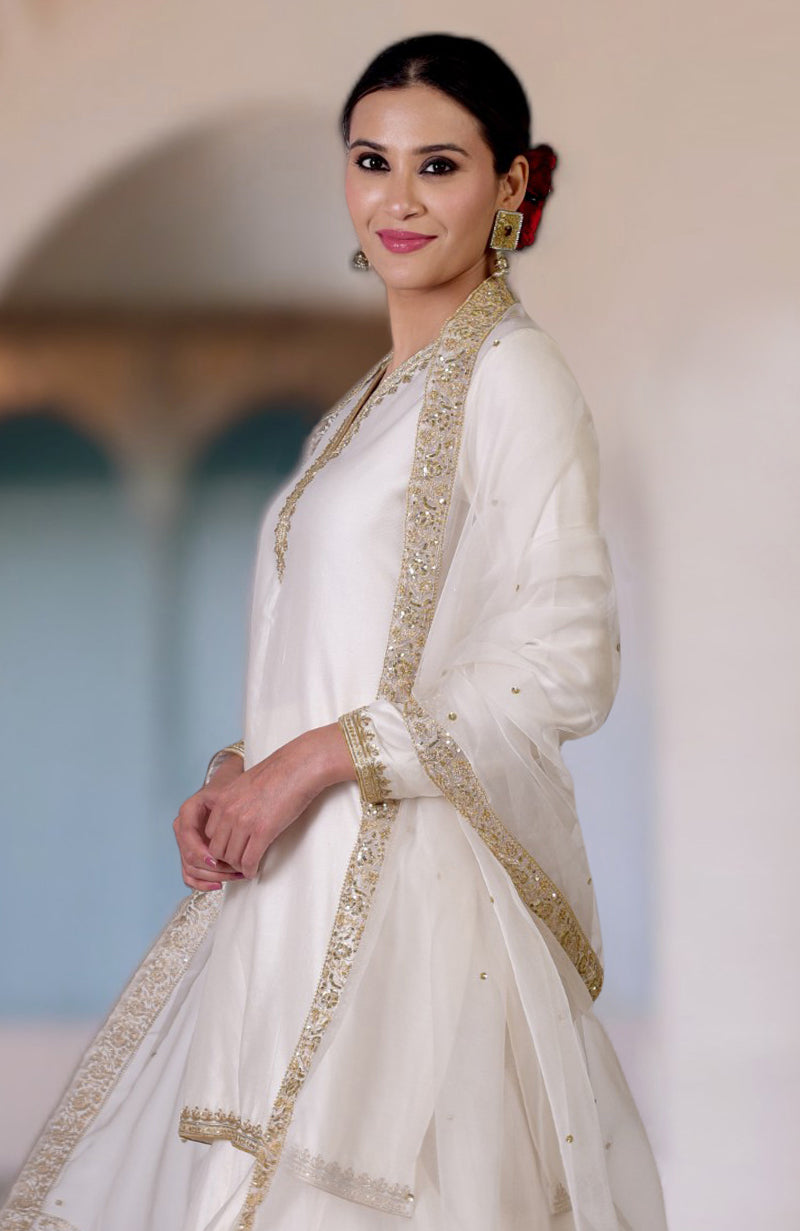 A woman in an ivory marori and zardozi hand-embroidered sharara set.