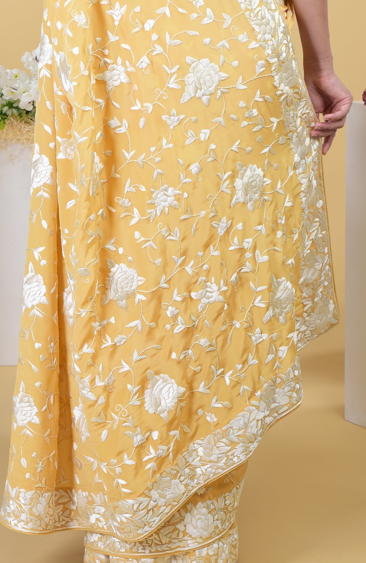 Mango yellow Parsi Gara hand-embroidered saree with intricate ivory floral patterns.
