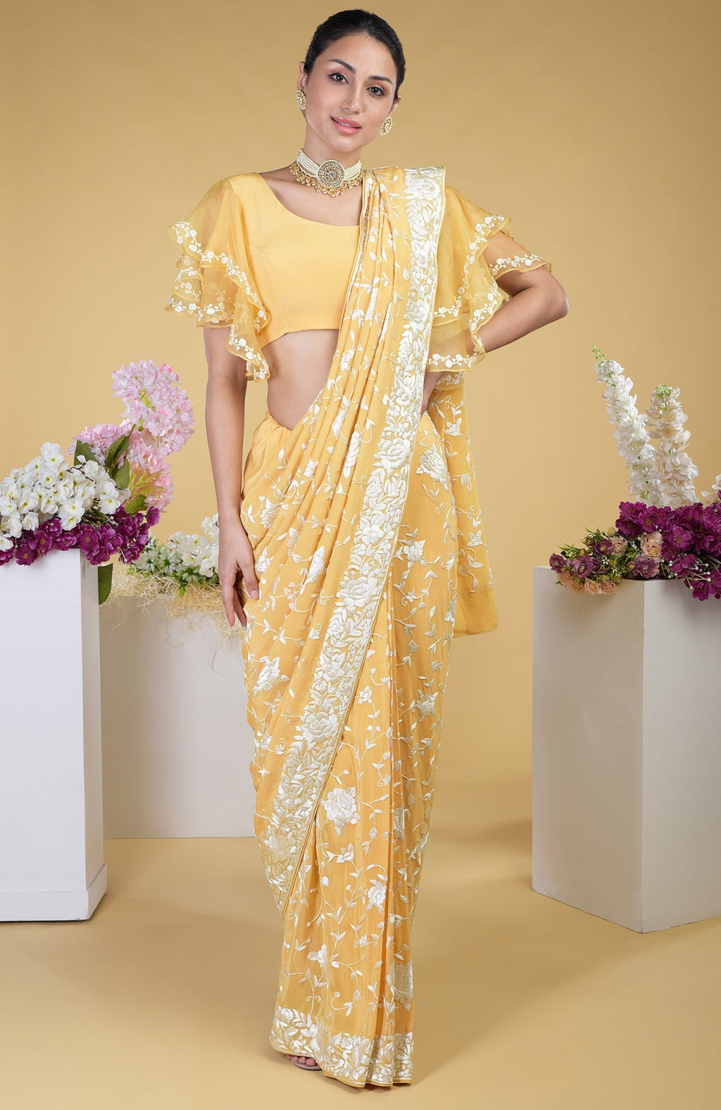 Mango yellow Parsi Gara hand embroidered saree with a frill detail blouse.