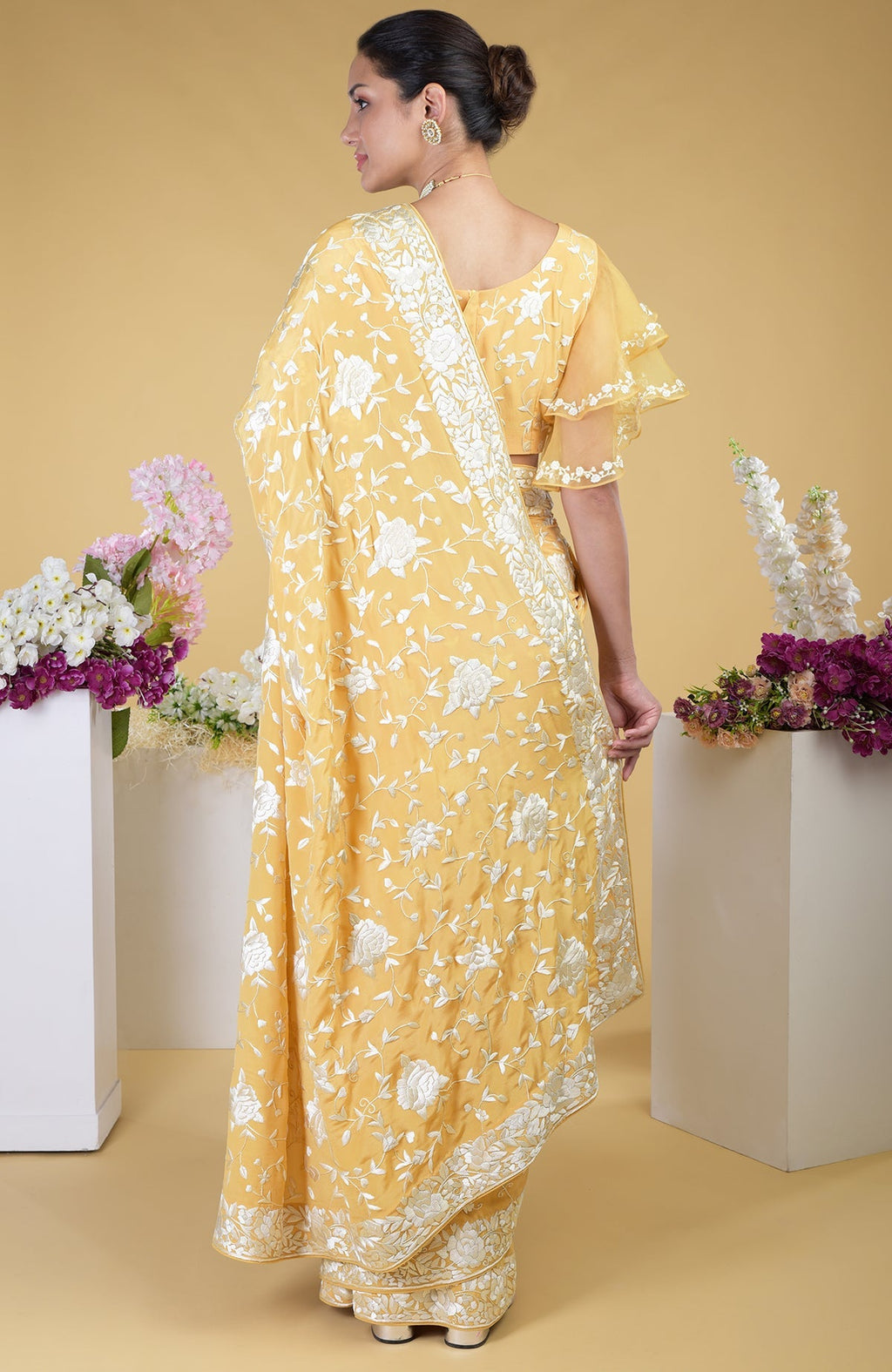 Mango yellow Parsi Gara hand-embroidered pure crepe saree with a frill-sleeved blouse.
