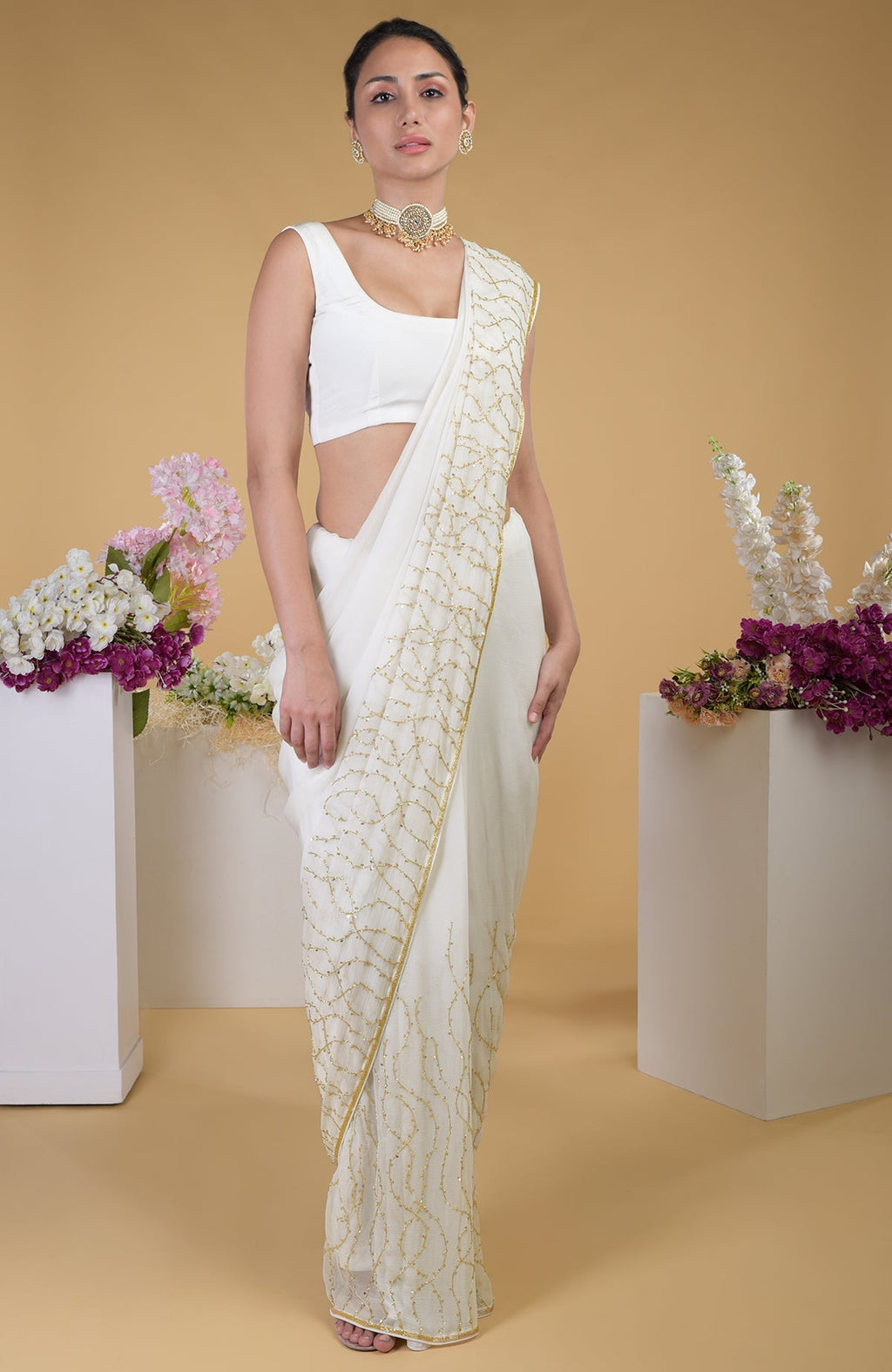 Ivory gold beads and sequin zardozi hand embroidered saree with a scoop neck blouse.