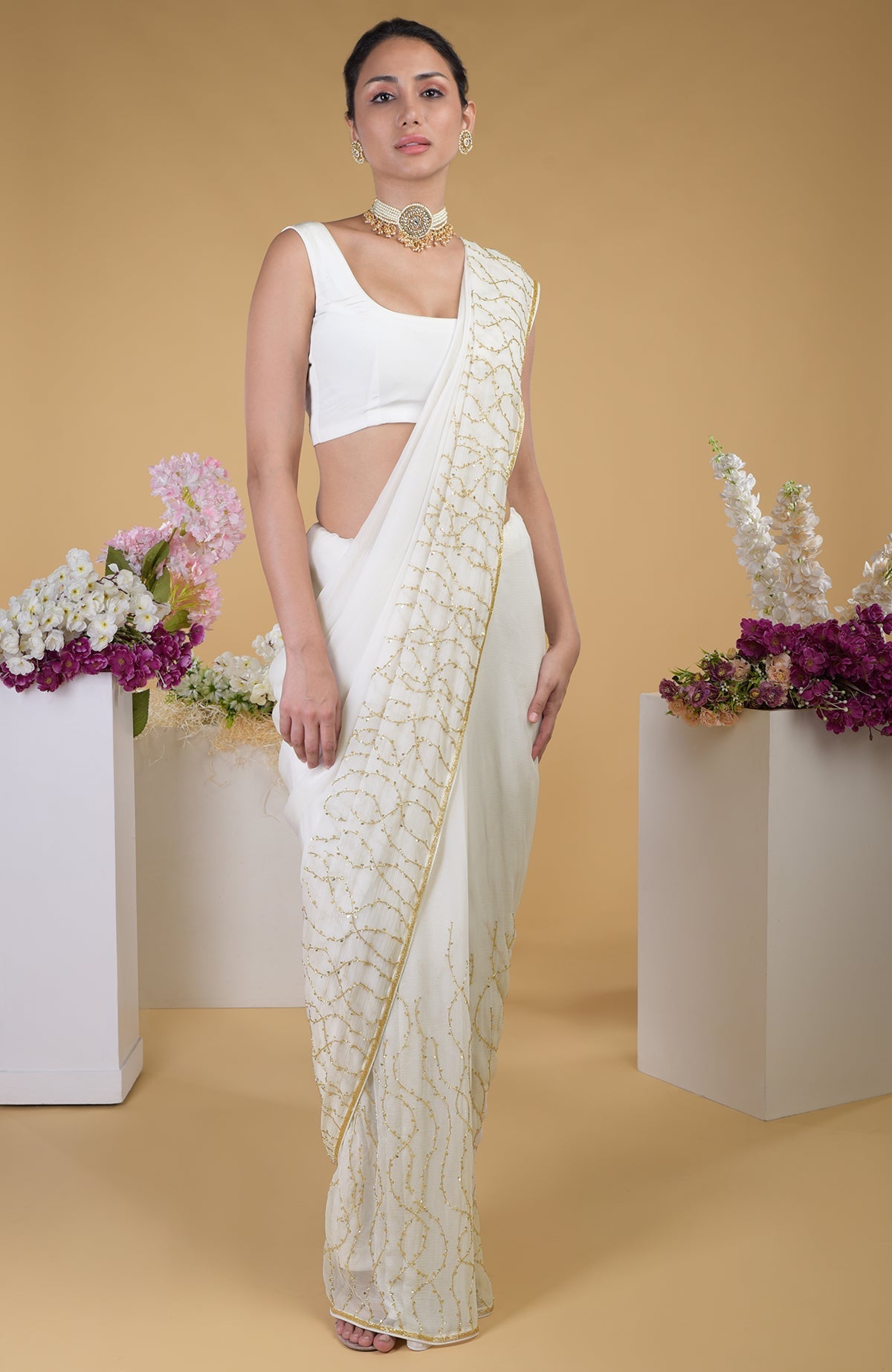 Ivory gold beads and sequin zardozi hand embroidered saree with a scoop neck blouse.