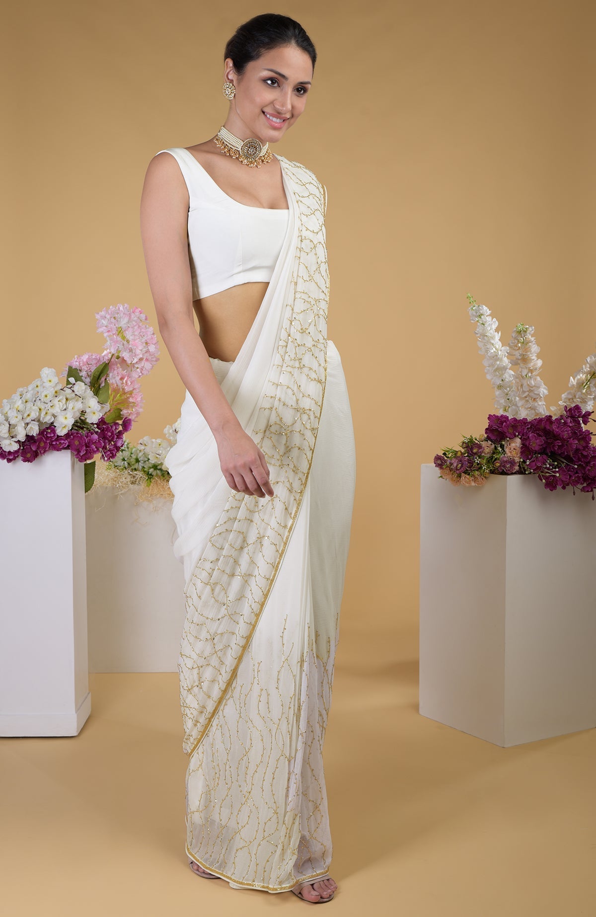 Ivory gold beads and sequin zardozi hand embroidered saree with a scoop neck blouse.