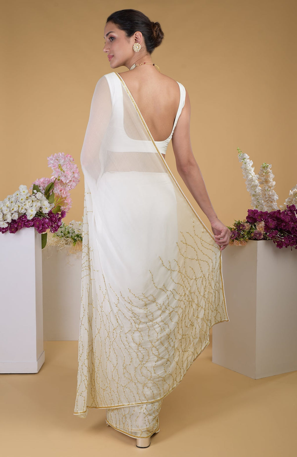 Ivory gold beads and sequin zardozi hand embroidered saree with a scoop neck blouse.