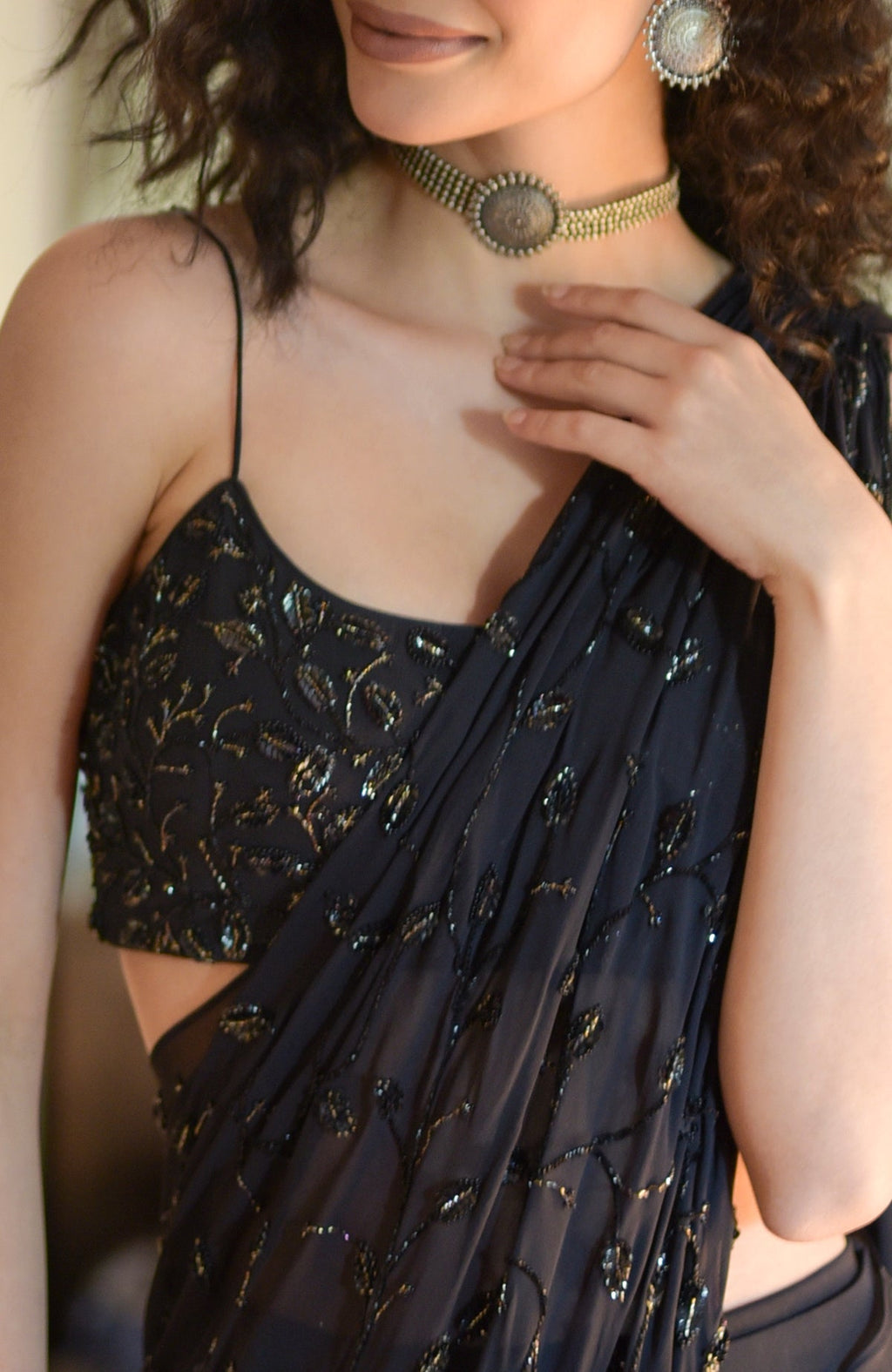 Black hand-beaded embroidered draped gown saree with a matching blouse and choker.