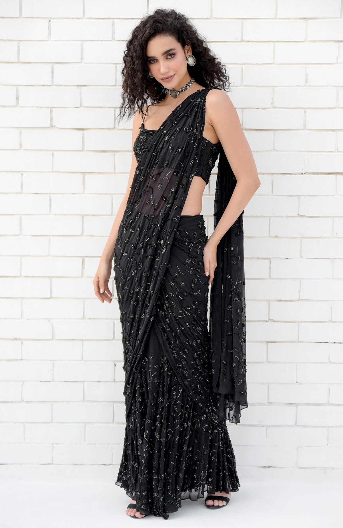 Black gown saree with hand beaded floral embroidery and pleated pallav drape on silk georgette.