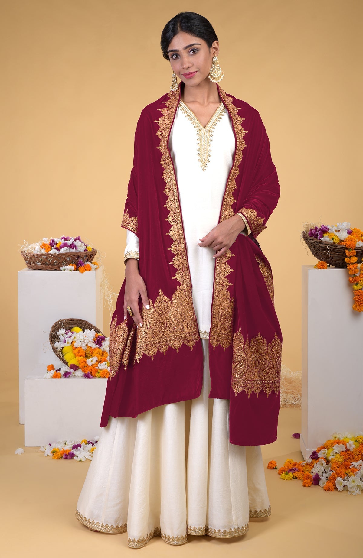 A woman models a claret Kashmiri tilla embroidered dupatta shawl over a white outfit.