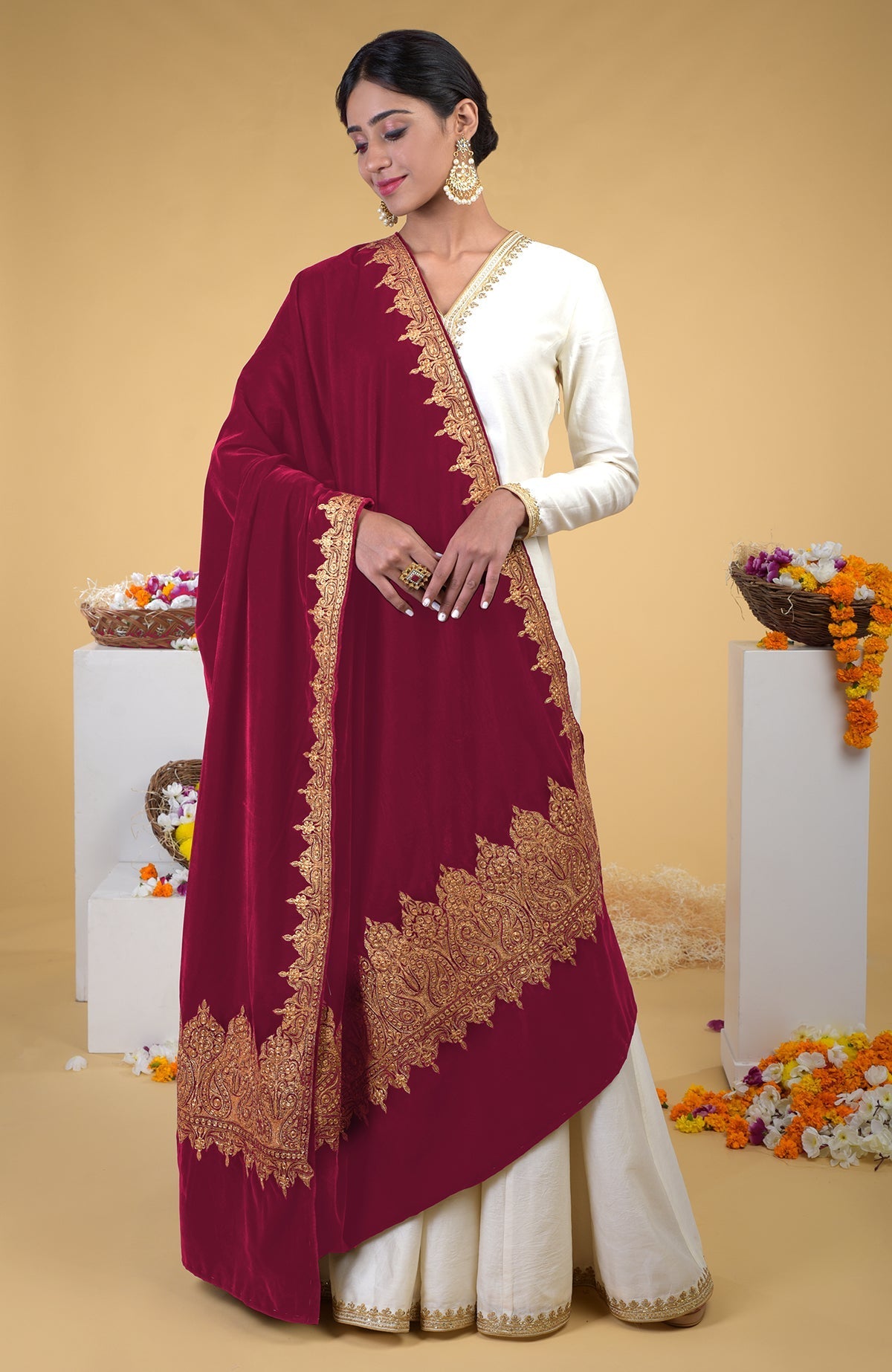 A woman models a claret Kashmiri tilla embroidered dupatta shawl over a white outfit.