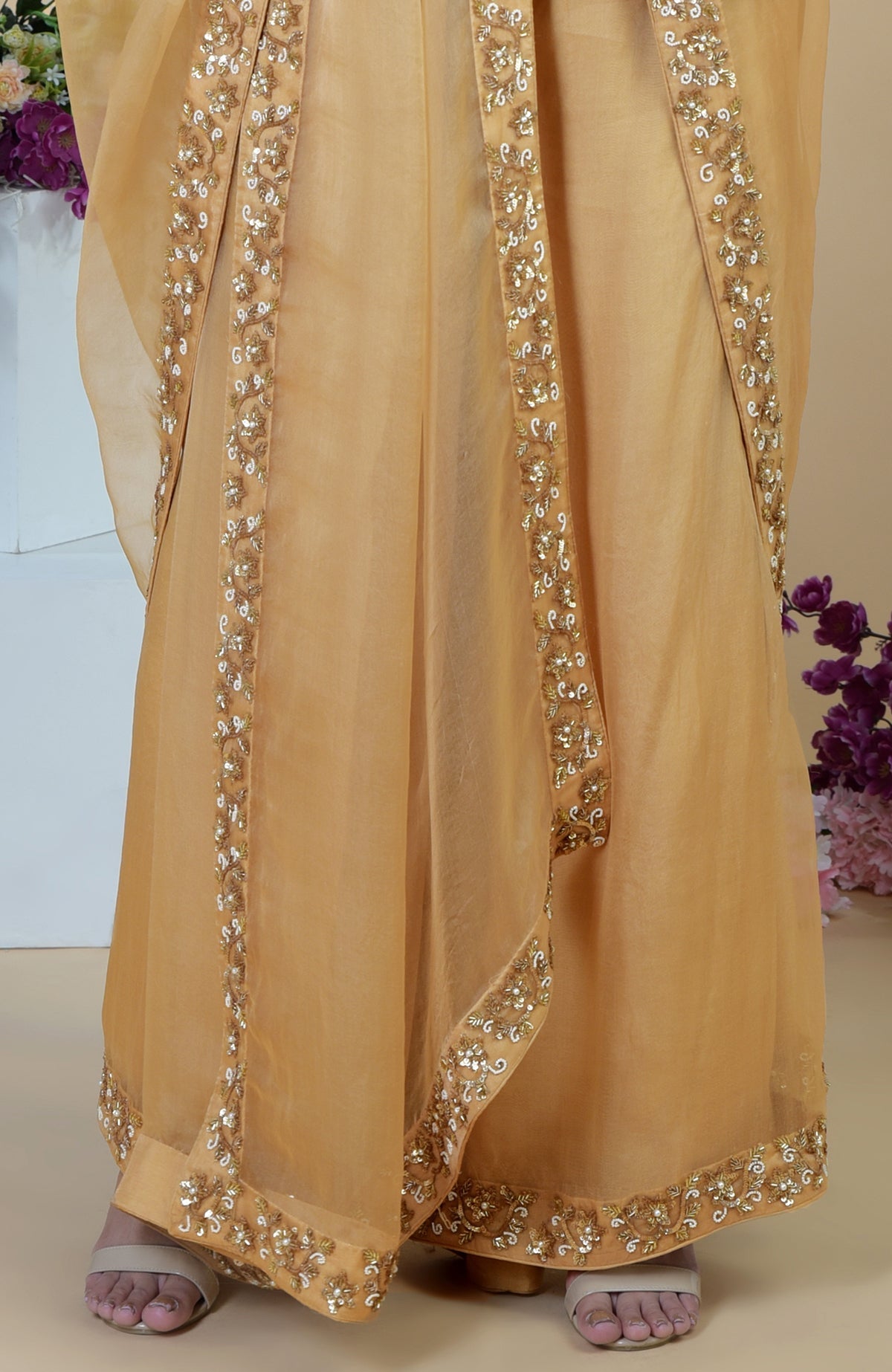 Gold organza sharara set with intricate zardozi hand embroidery.