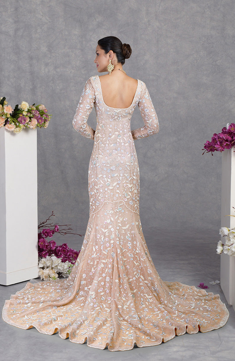 Ethereal fishcut gown with pastel floral embroidery on delicate silk organza and a graceful trail.