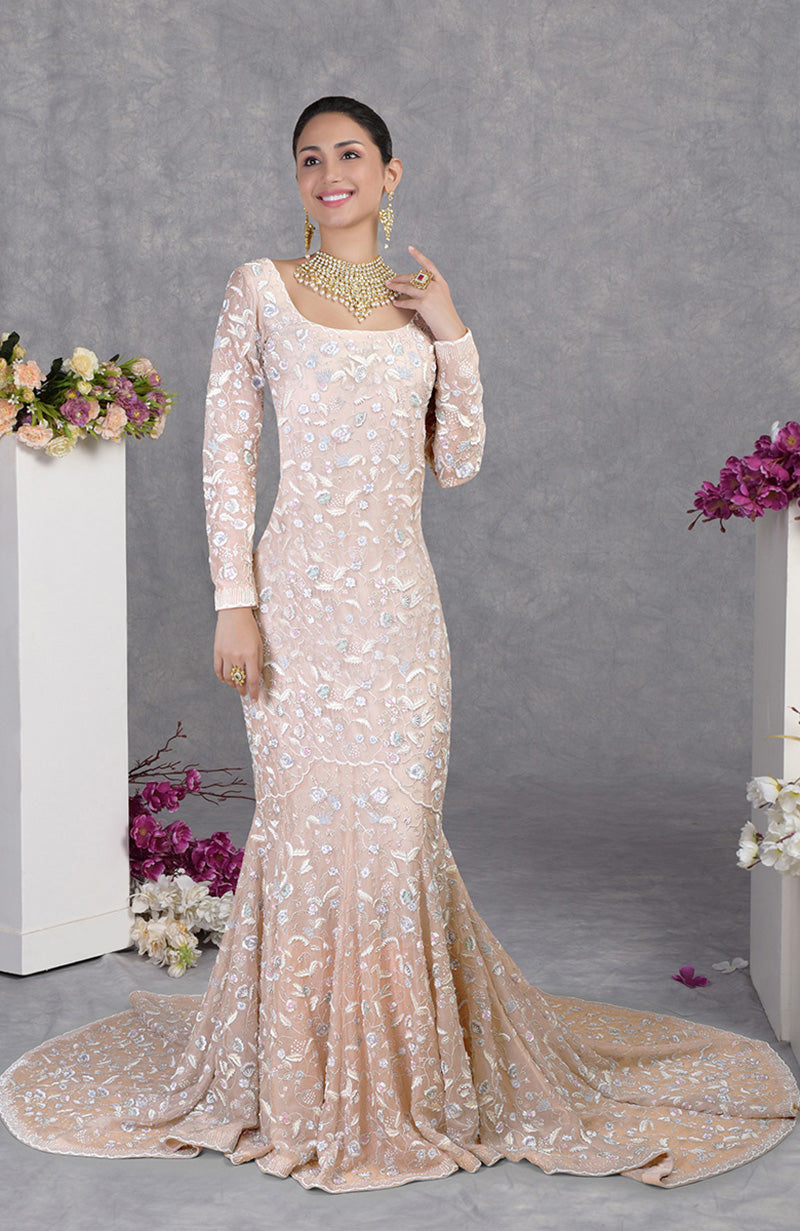 Ethereal fishcut gown with pastel floral embroidery on delicate silk organza and a graceful trail.