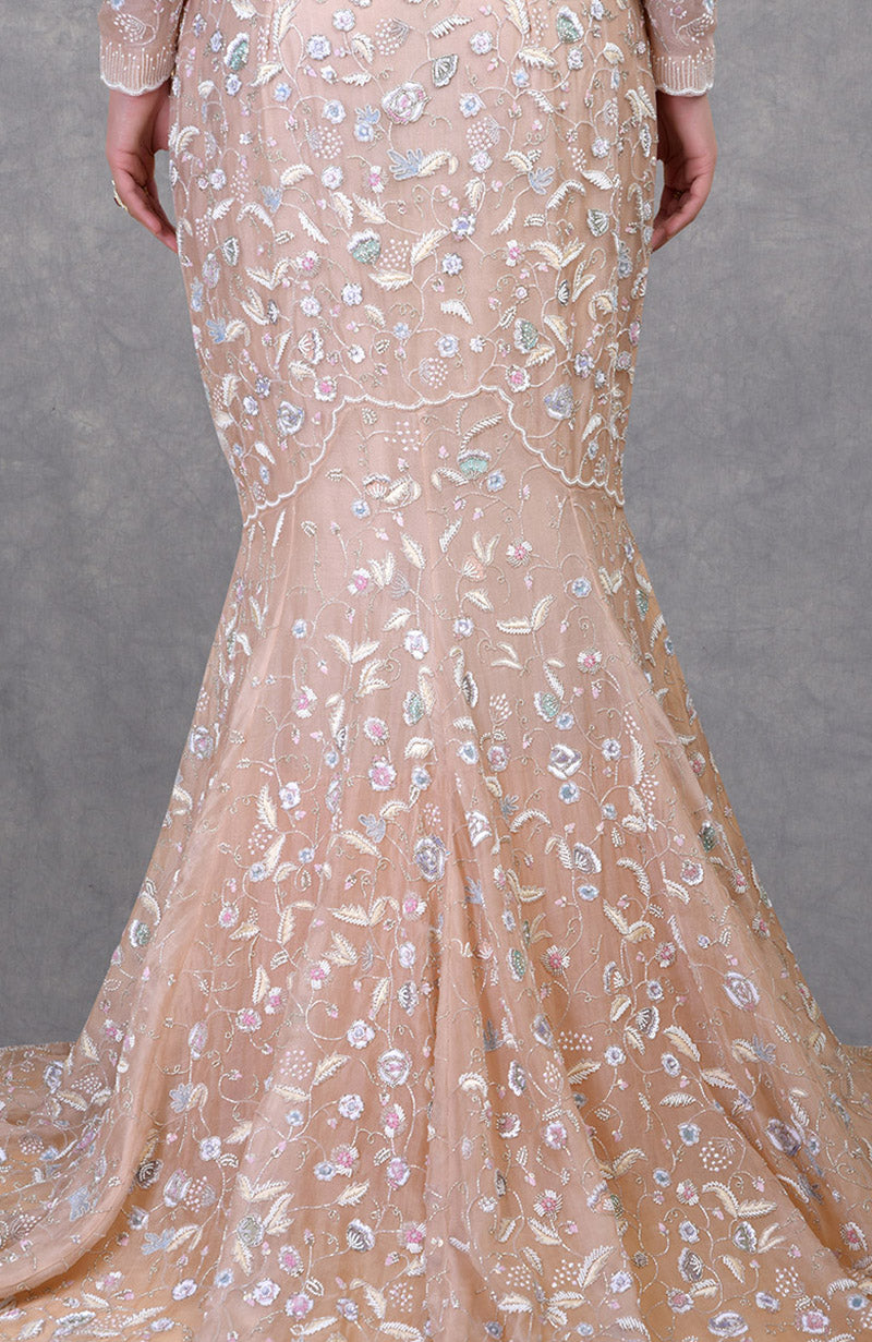 Ethereal fishcut gown with pastel floral embroidery on delicate silk organza and a trailing hem.
