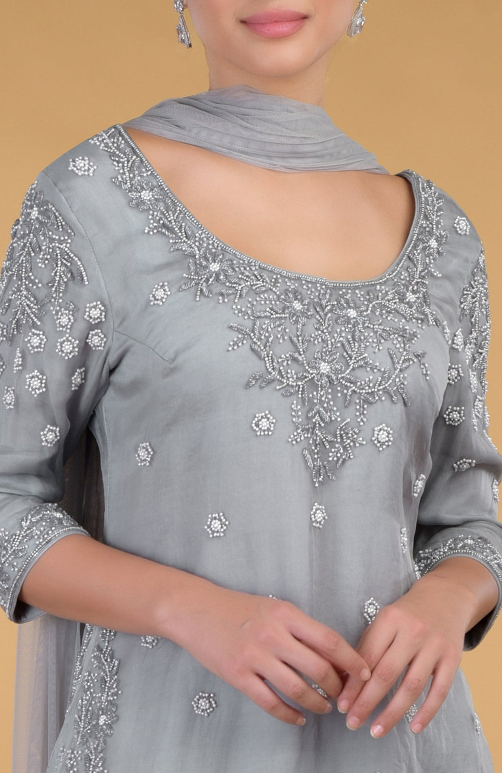 Grey silk organza kurta set with intricate hand embroidery and pearl embellishments.
