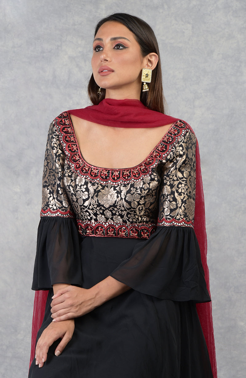 Black Anarkali set with gold brocade yoke, black and red bead embroidery, paired with churidar pants and red dupatta