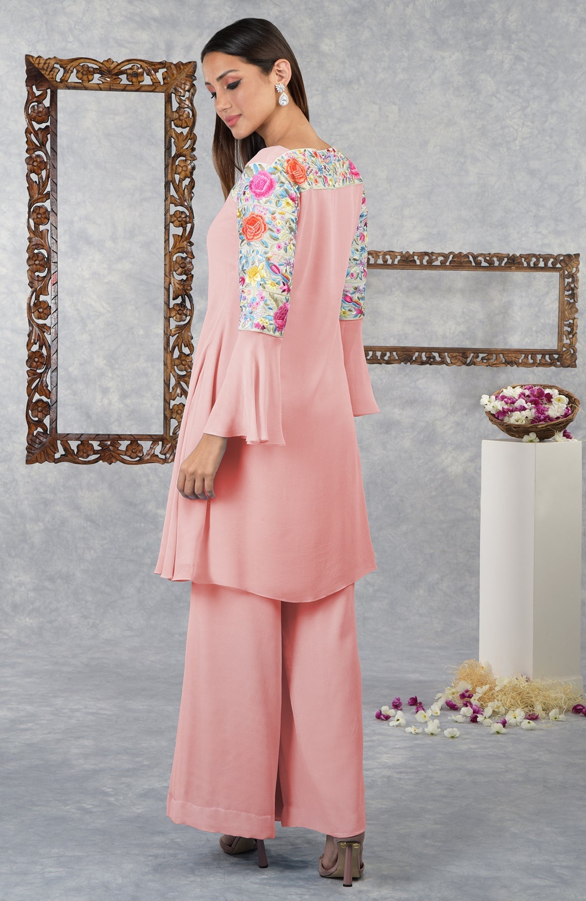 An Impatiens Pink Parsi Gara Embroidered Kurta Set with bell sleeves.