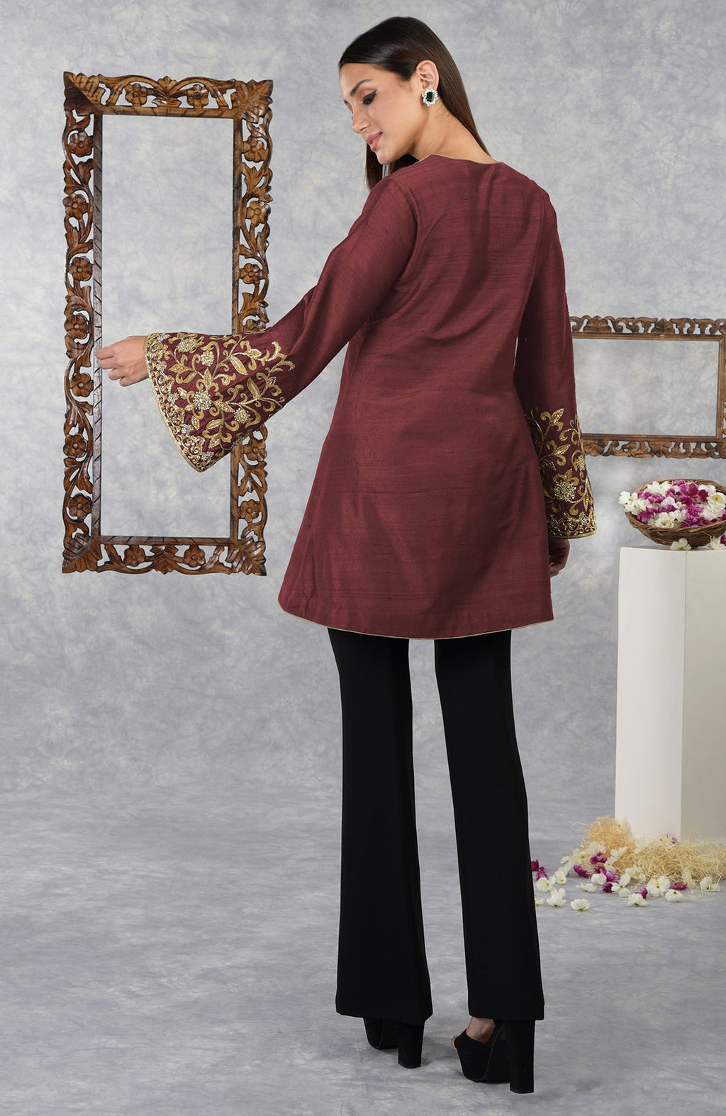 Pomegranate raw silk jacket with gold hand embroidery on the sleeves, paired with black pants.