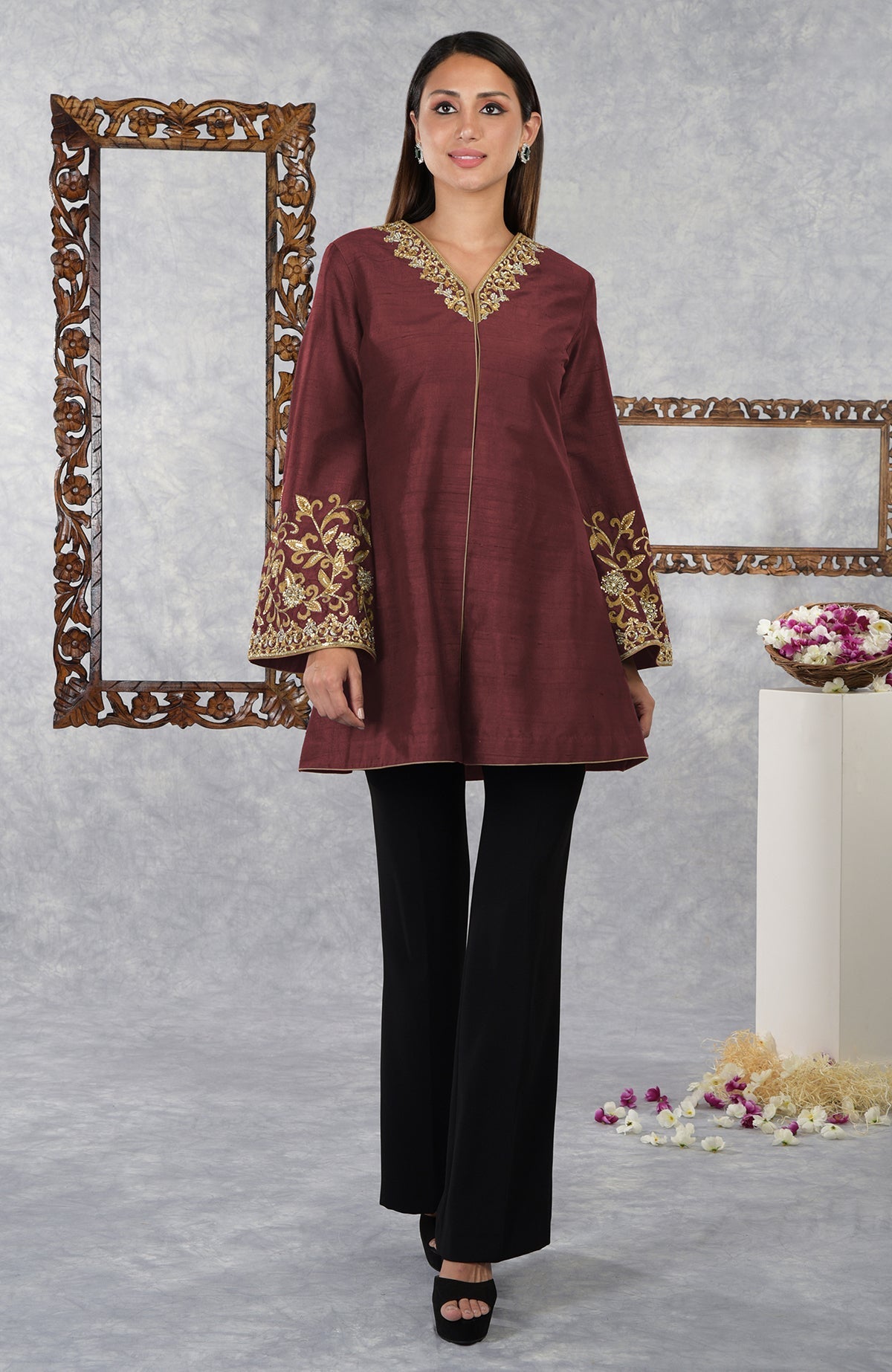 Maroon raw silk hand-embroidered jacket with black high-waisted flared pants.