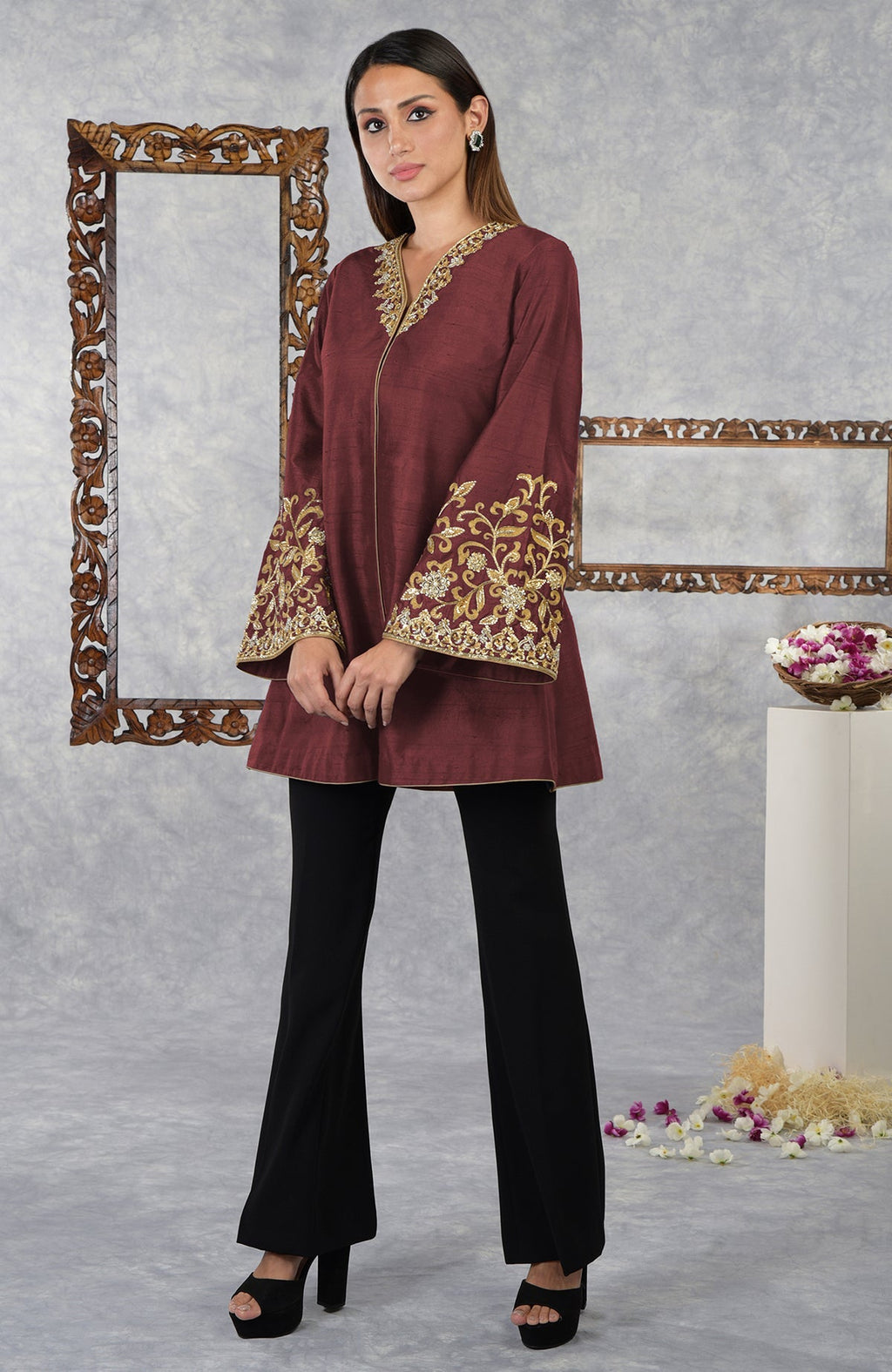 Pomegranate raw silk hand-embroidered jacket with black pants and platform heels.