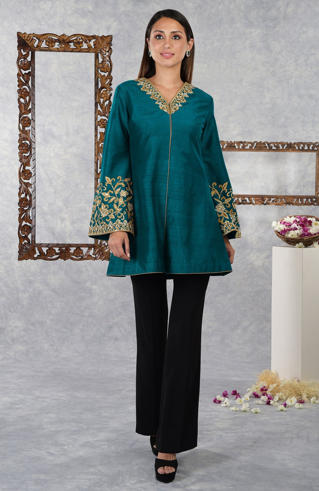 Deep teal raw silk hand embroidered jacket with black pants.