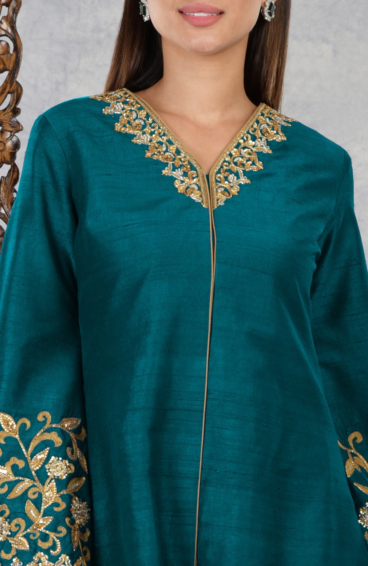 Deep teal raw silk jacket with gold and silver hand embroidery on the neckline and sleeves.