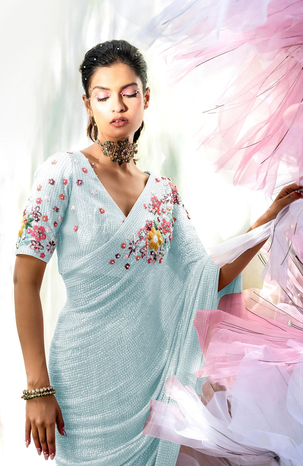 Aqua blue floral sequin saree with a matching blouse and a statement choker.