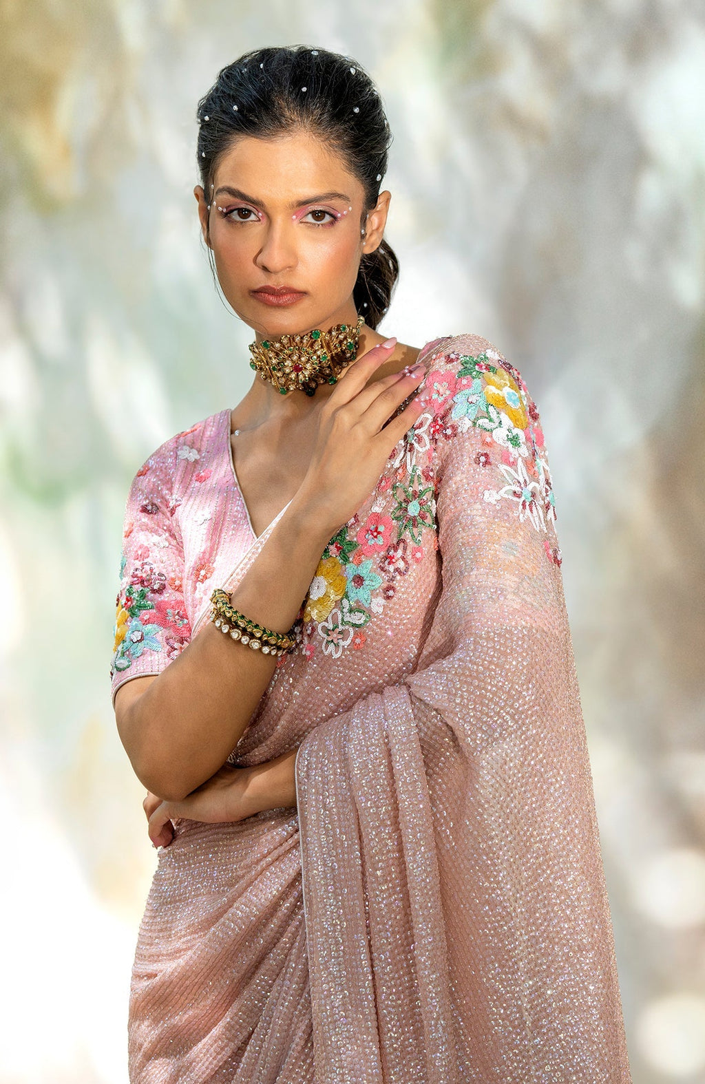 Pink champagne floral sequin hand-embroidered saree with a matching blouse.