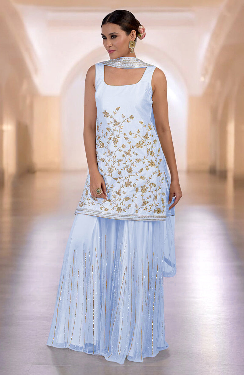 An ice blue sharara set with gold floral embroidery and a matching dupatta.