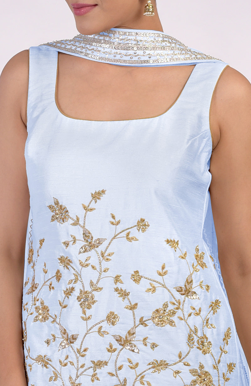 Ice blue sleeveless kurta with gold floral embroidery and a sequined scarf.