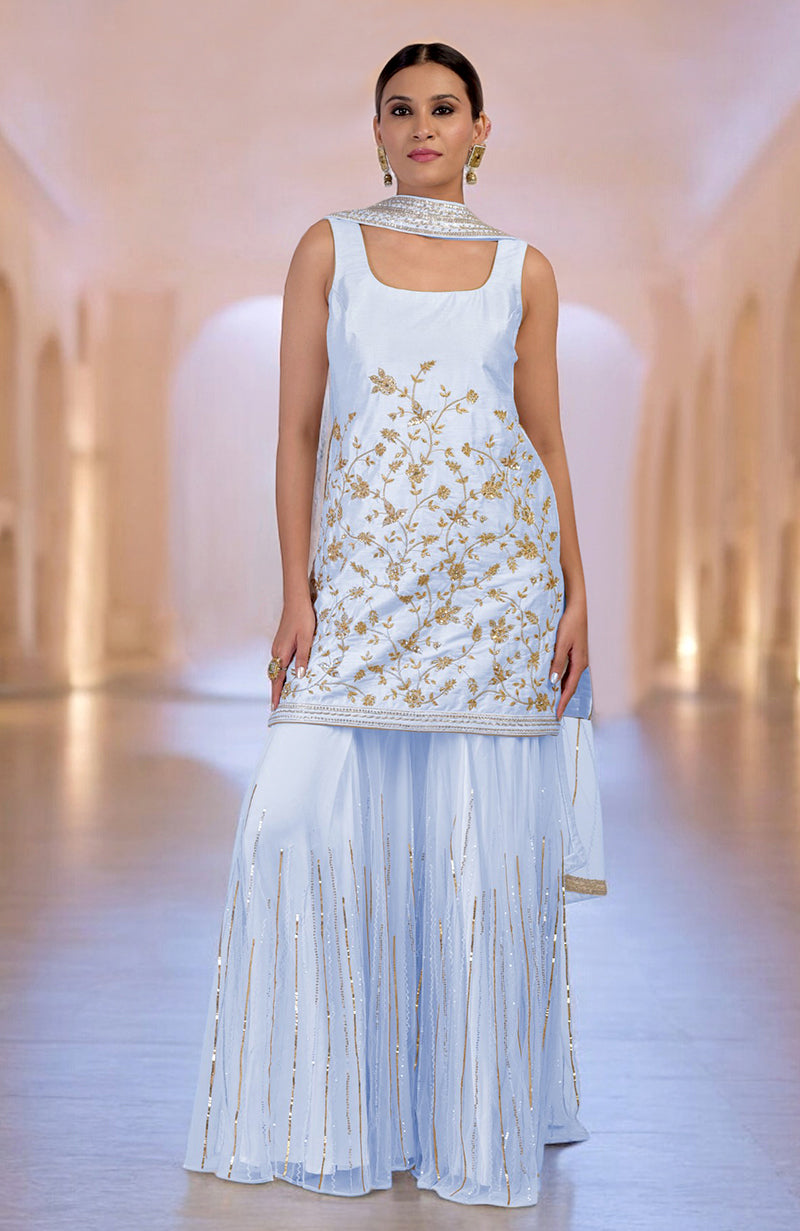 An ice blue sharara set with gold floral embroidery and a matching dupatta.