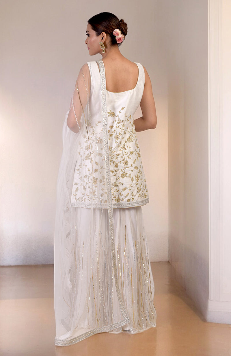 White-gold hand-embroidered raw silk-tulle sharara set with floral motifs and sequins.